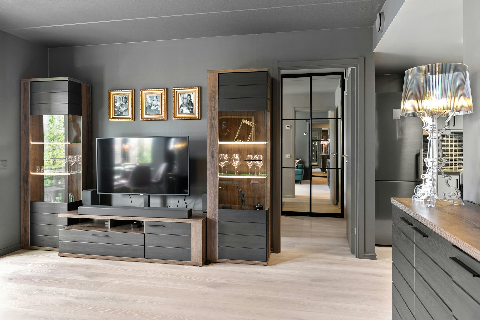 A living room with a TV and a large window